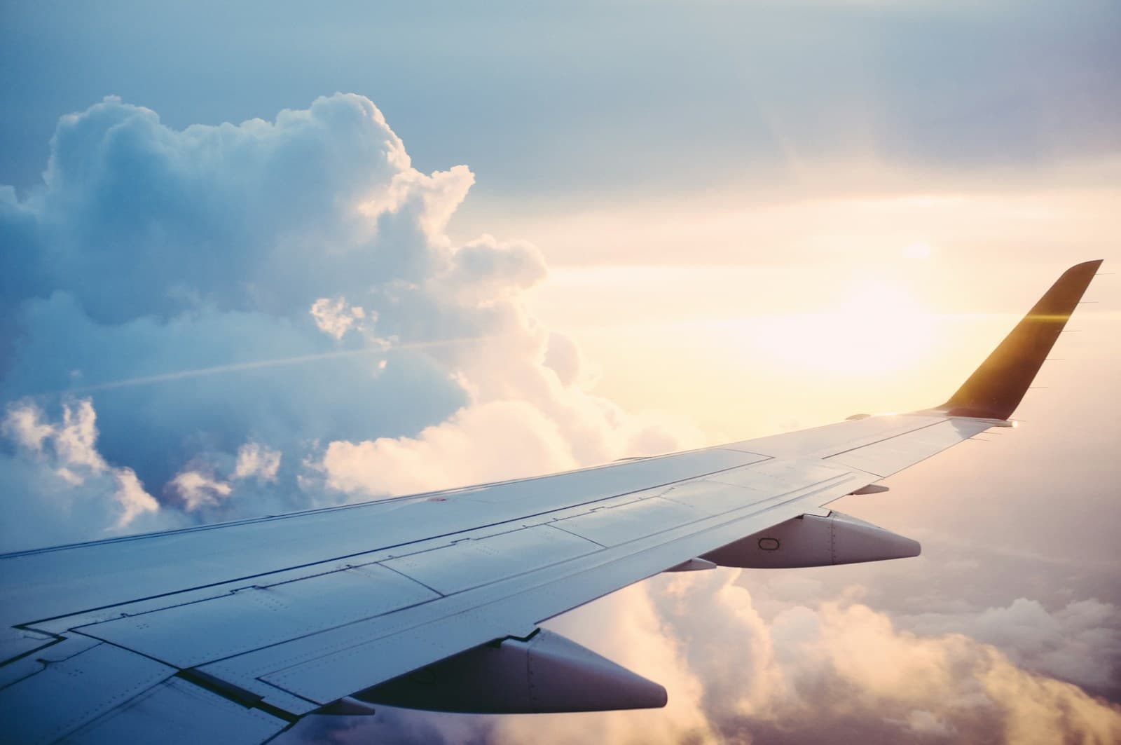 Aircraft travelling above the clouds at sunrise