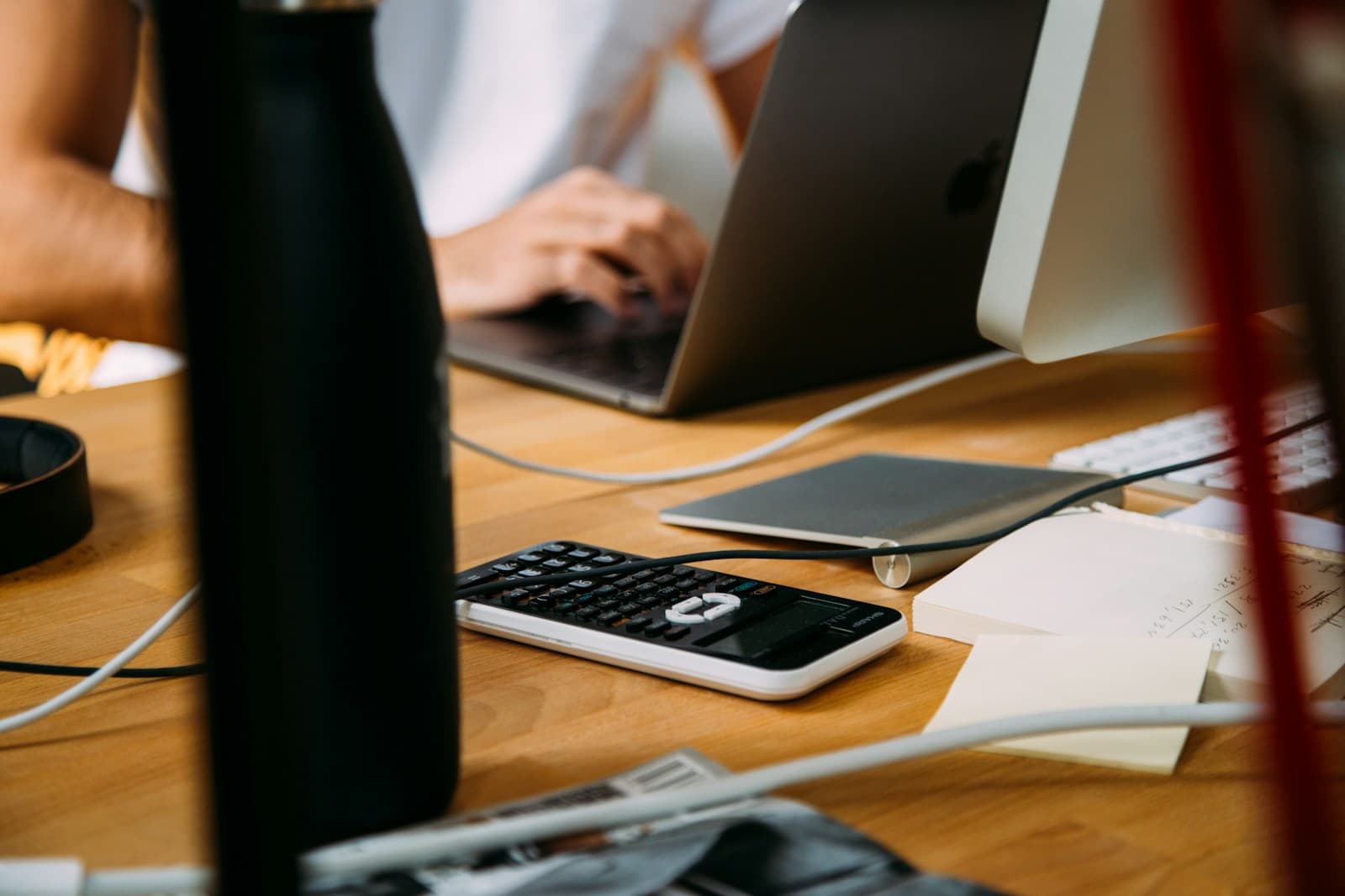 Calculator, pen and financial papers arranged for an accounts review