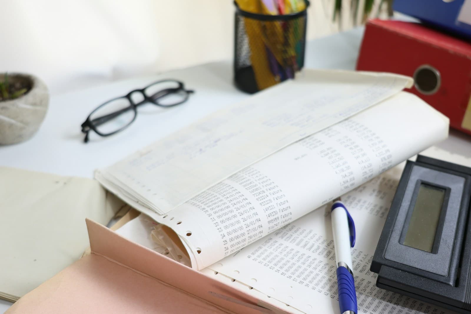 Financial records, calculator and office materials prepared for review