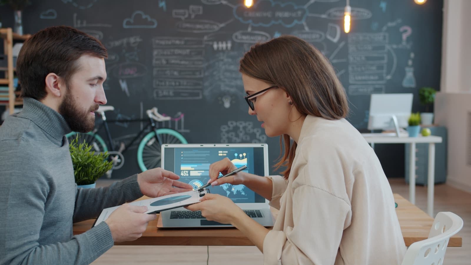 Two colleagues reviewing business charts and financial information