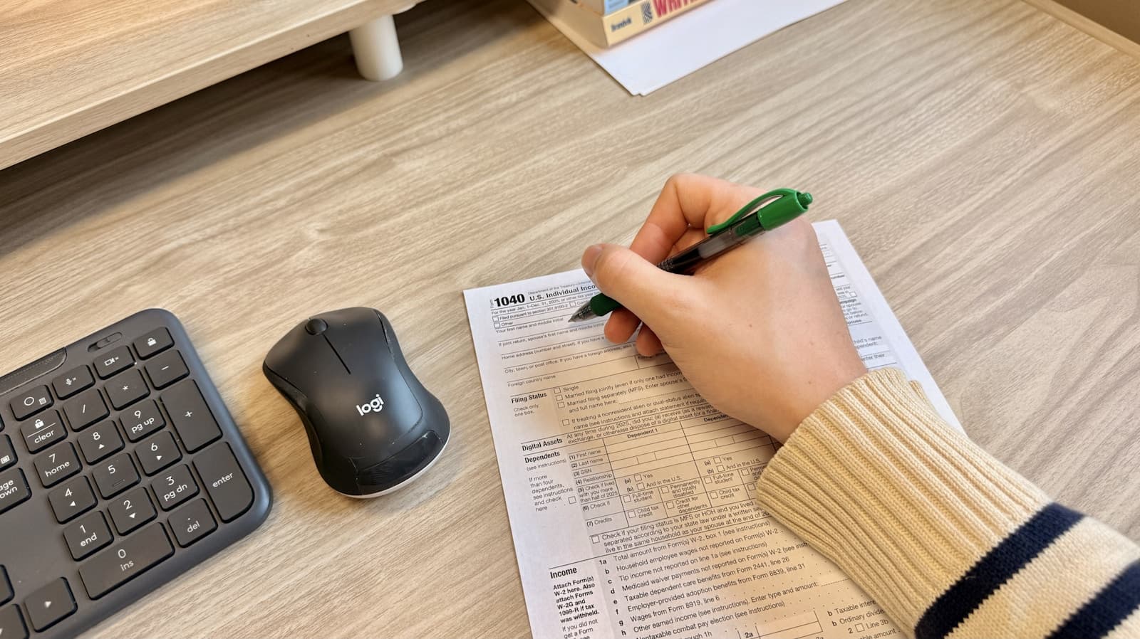 Person maintaining digital financial records at a computer