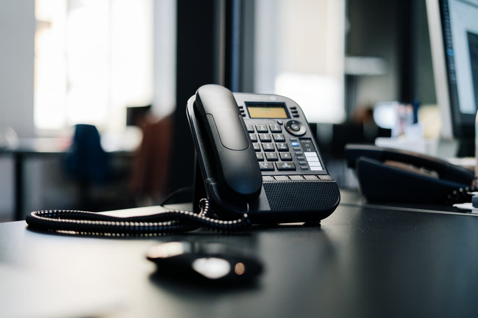 Modern IP desk phone in a professional workspace